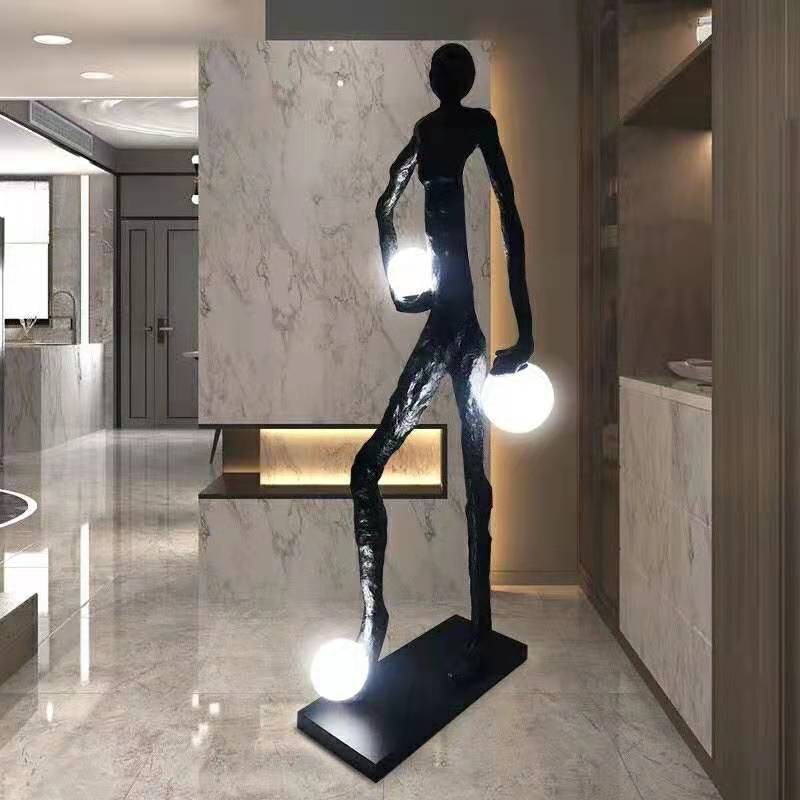 A lamp which is shape of man holding those lights named as Lucifero Lamp